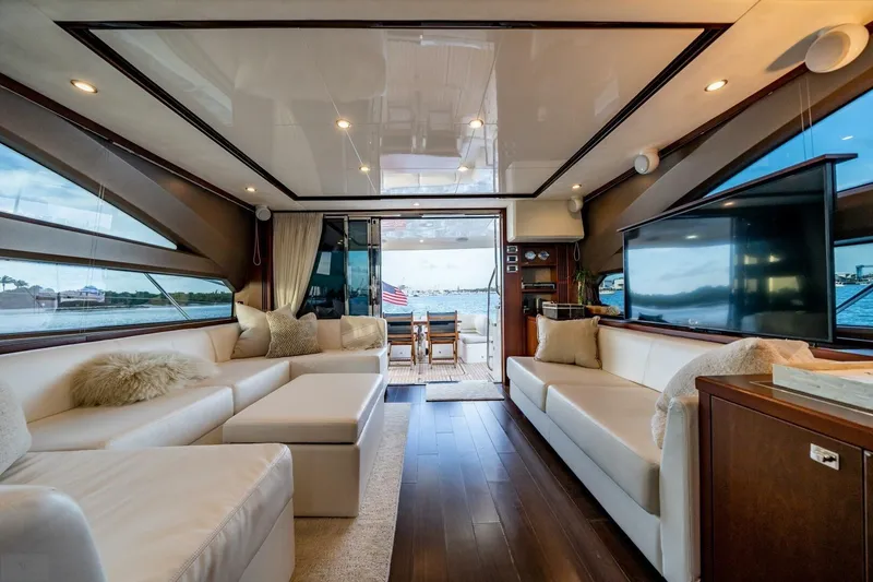 Slide: The Image of Luxurious 2012 Princess 64 Flybridge Motor Yacht with elegant seating and scenic marina view. - 10