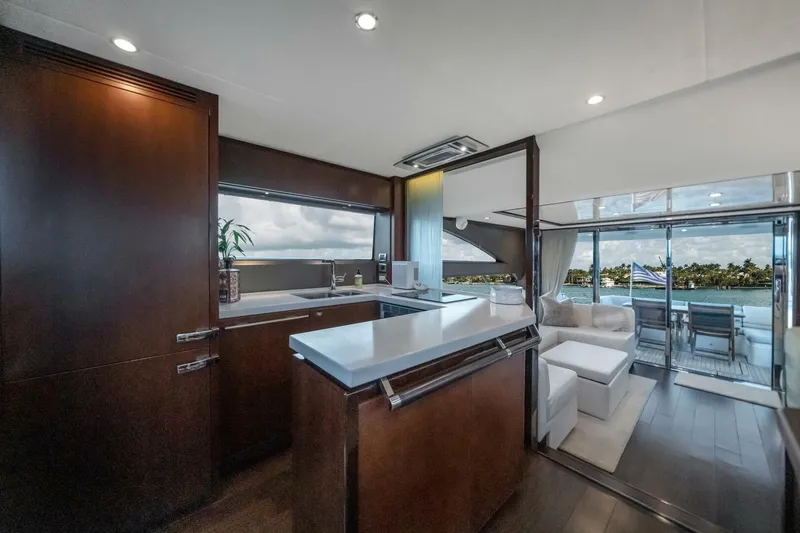 Slide: The Image of Luxurious 2012 Princess 64 Flybridge Motor Yacht with elegant outdoor seating and scenic marina view. - 16