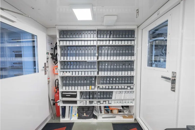 Slide: The Image of Storage room on 2013 Feadship Motor Yacht with organized binders and safety equipment. - 74