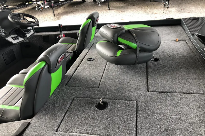 Slide: The Image of 2026 Ranger RT178 boat interior with green and gray seats, carpeted deck, and steering console. - 10
