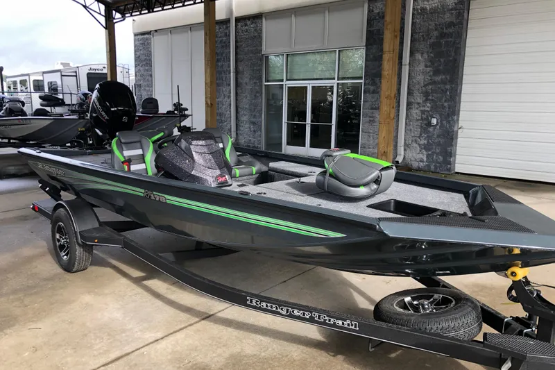 Slide: The Image of 2026 Ranger RT178 boat with green accents on a trailer, parked outdoors. - 15