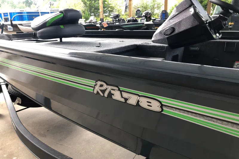 Slide: The Image of 2026 Ranger RT178 boat with green stripes, featuring a sleek design and comfortable seating. - 2