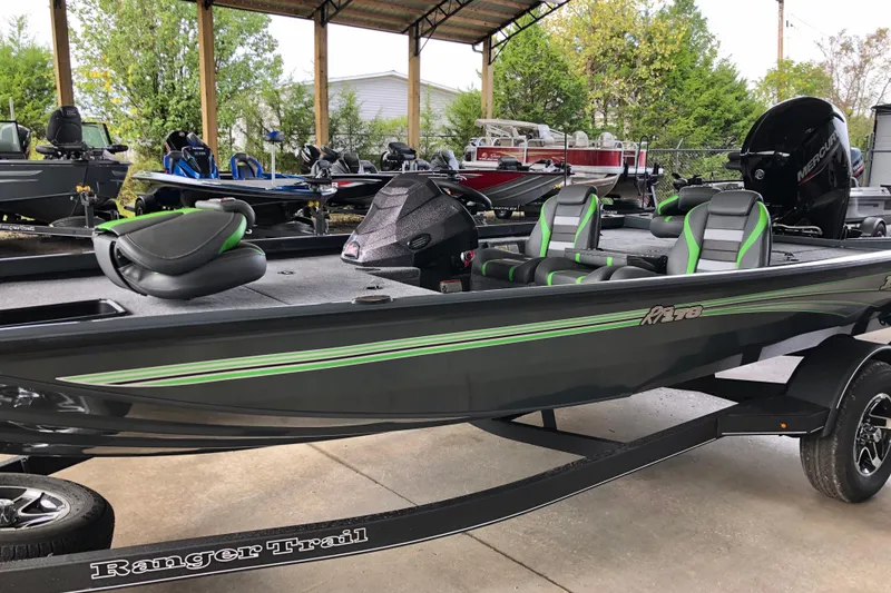 Slide: The Image of 2026 Ranger RT178 boat with green accents, parked on a trailer in a covered area. - 3