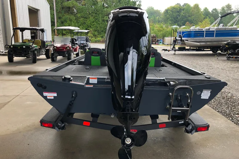 Slide: The Image of 2026 Ranger RT178 boat with outboard motor, parked near utility vehicles and a pontoon boat. - 5