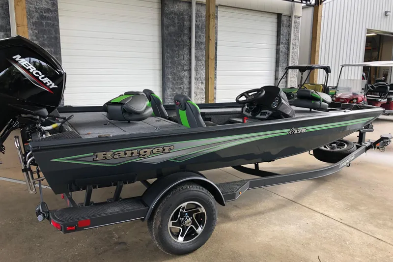 Slide: The Image of 2026 Ranger RT178 fishing boat with Mercury engine, parked on a trailer in a garage. - 6