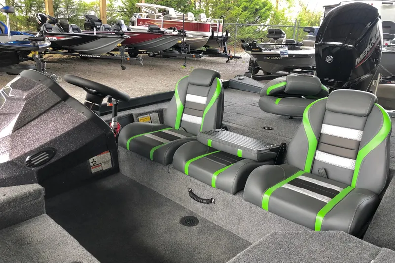 Slide: The Image of 2026 Ranger RT178 boat interior with green-accented seats, steering wheel, and multiple boats in the background. - 8