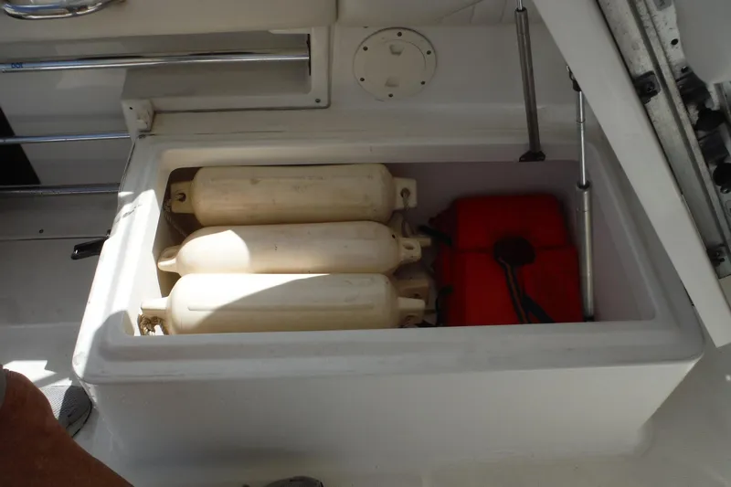 Slide: The Image of Storage compartment on 2007 Robalo R227 Dual Console with fenders and life jacket. - 14
