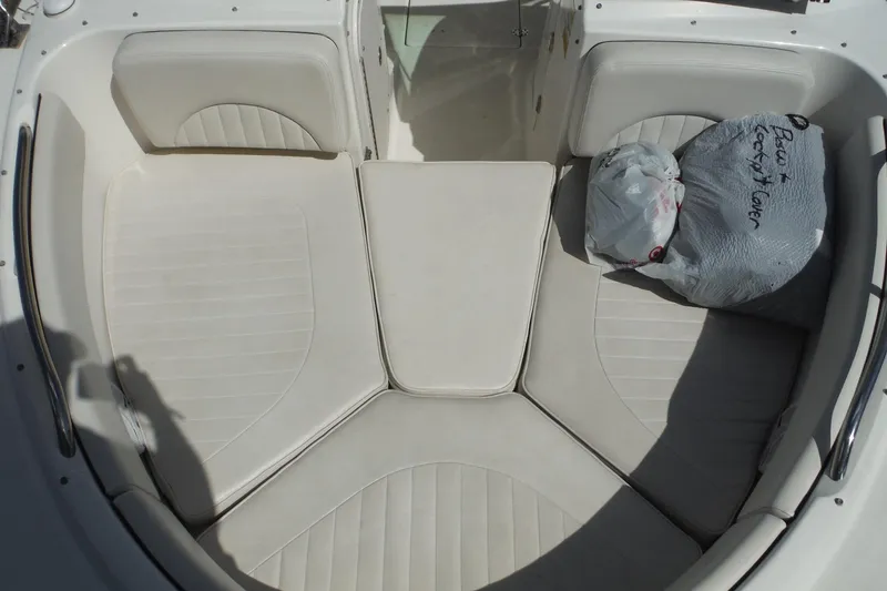Slide: The Image of 2007 Robalo R227 Dual Console boat interior with white seating and storage bag. - 18