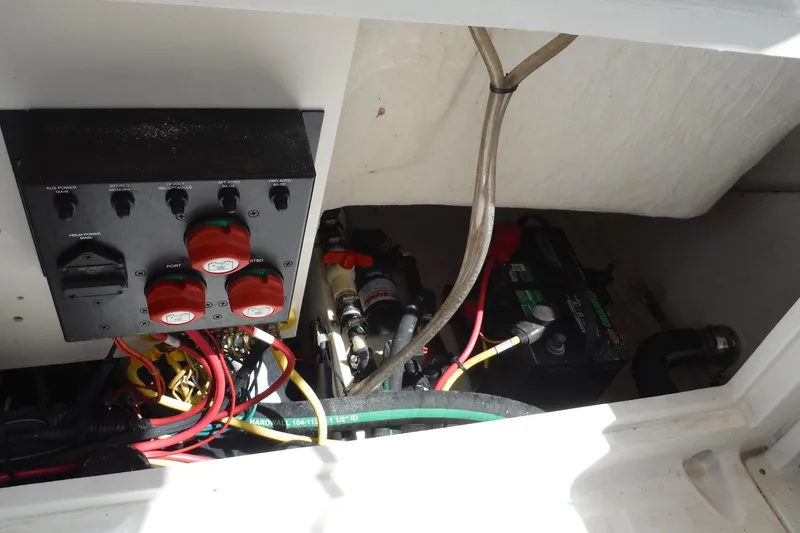 Slide: The Image of 2007 Robalo R227 Dual Console boat electrical panel and battery compartment. - 22