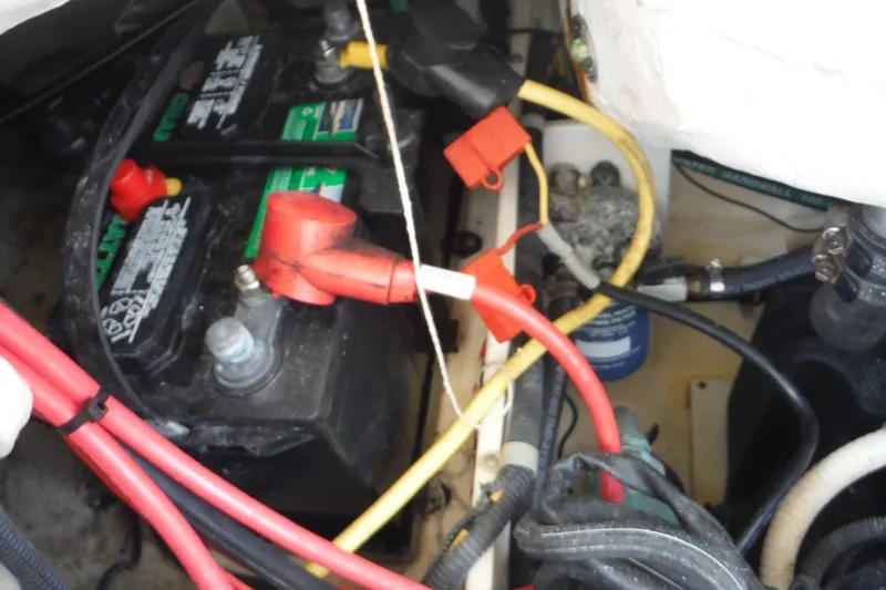 Slide: The Image of Battery compartment of a 2007 Robalo R227 Dual Console boat with cables and connections. - 24