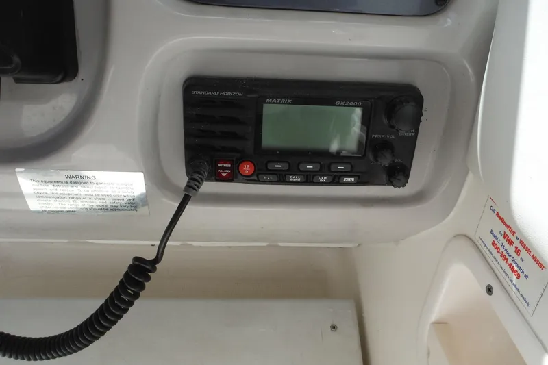 Slide: The Image of 2007 Robalo R227 Dual Console boat radio system with control panel and microphone. - 30