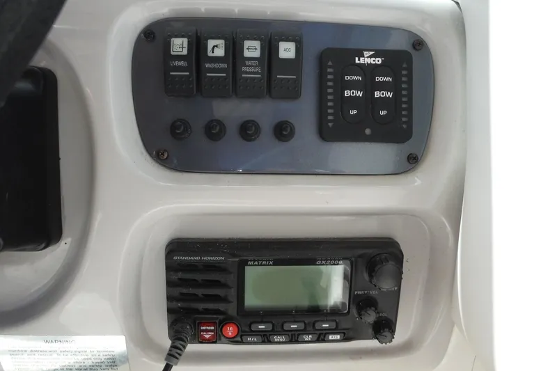 Slide: The Image of Control panel of a 2007 Robalo R227 Dual Console boat with switches and radio. - 31