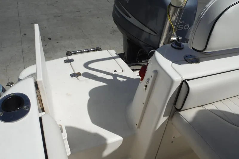 Slide: The Image of 2007 Robalo R227 Dual Console boat interior with seating and engine view. - 33