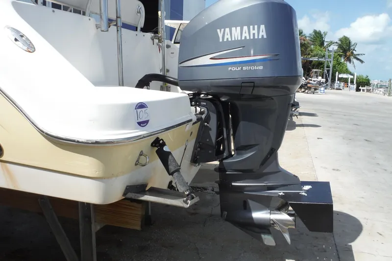 Slide: The Image of 2007 Robalo R227 Dual Console with Yamaha four-stroke outboard motor on a dock. - 4