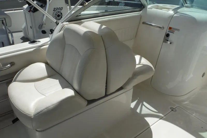 Slide: The Image of 2007 Robalo R227 Dual Console boat interior with white seating and console. - 8
