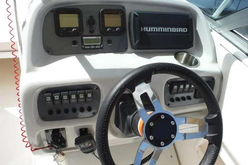 Slide: The Image of 2007 Robalo R227 Dual Console dashboard with steering wheel and Humminbird electronics. - 9