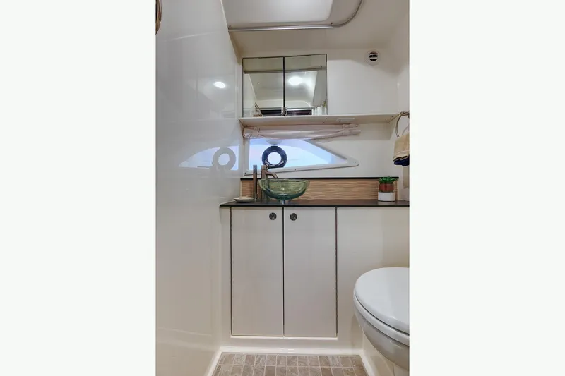 Slide: The Image of Manufacturer Provided Image: 2025 Sea Ray Sundancer 320 bathroom with modern fixtures and compact design. - 16
