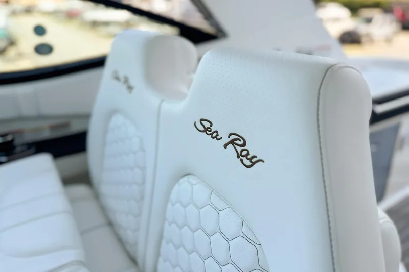 Slide: The Image of 2026 Sea Ray Sundancer 320 storage compartment with white interior and circular cover. - 19