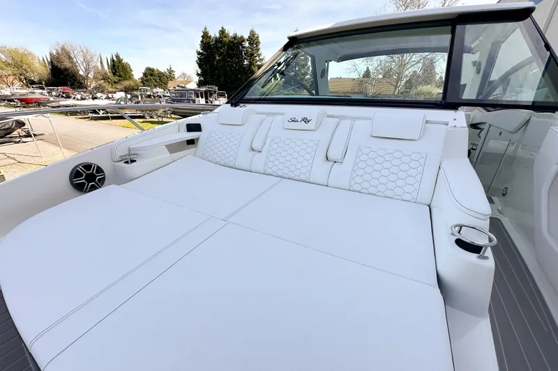 Slide: The Image of 2026 Sea Ray Sundancer 320 boat interior with sleek white seating and chrome details. - 36