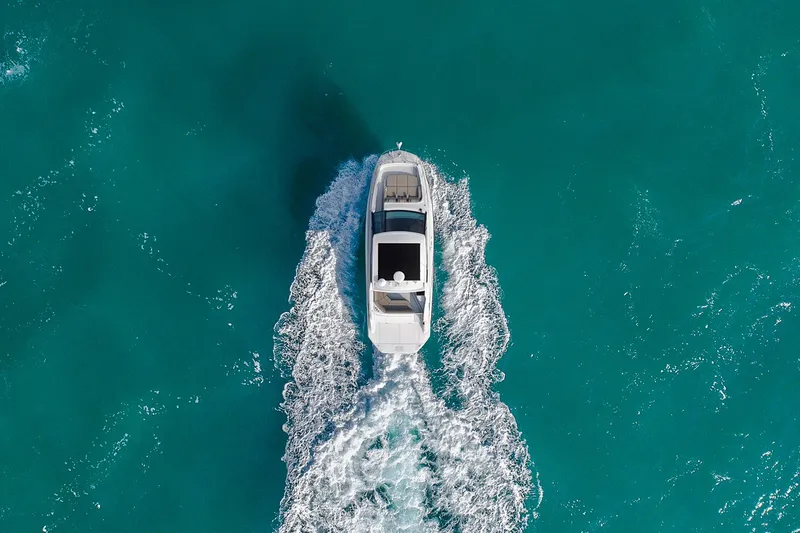 Slide: The Image of Manufacturer Provided Image: Aerial view of 2025 Sea Ray Sundancer 320 cruising on turquoise water. - 4