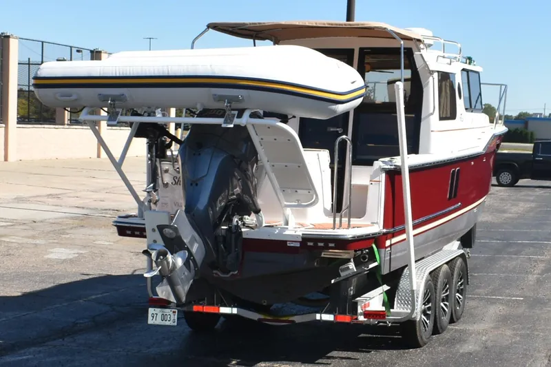 Slide: The Image of 2024 Ranger Tugs R-27 boat on trailer with inflatable dinghy attached. - 10
