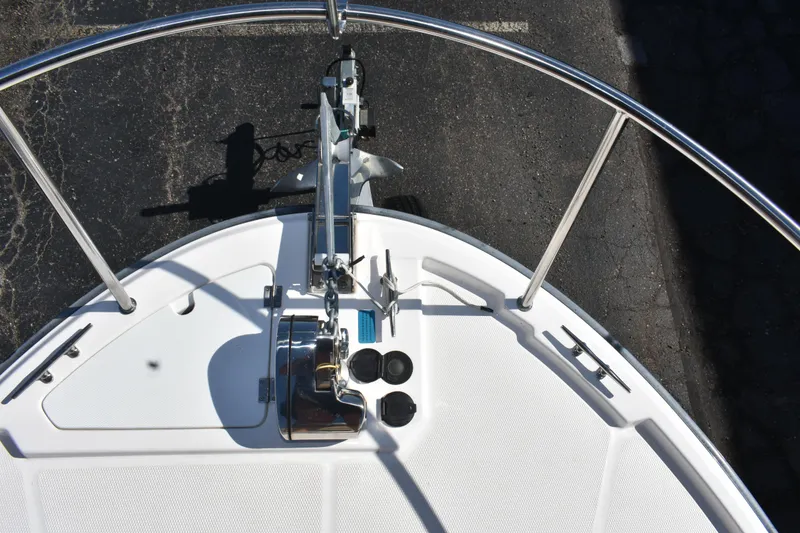 Slide: The Image of 2024 Ranger Tugs R-27 boat bow with anchor and stainless steel railings. - 16