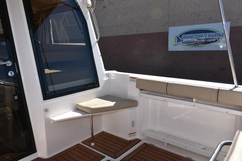 Slide: The Image of 2024 Ranger Tugs R-27 boat interior with seating, docked at Grand Pointe Marina. - 20