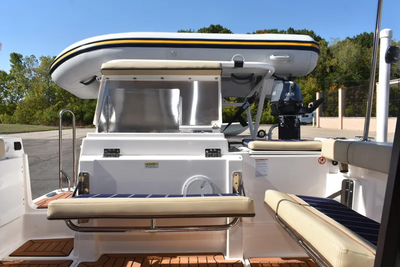 Slide: The Image of 2024 Ranger Tugs R-27 boat with seating and mounted inflatable dinghy. - 26