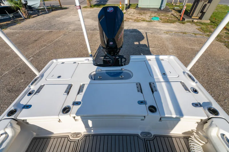 Slide: The Image of 2020 Tidewater 2500 Carolina Bay boat deck with motor, featuring storage compartments. - 17
