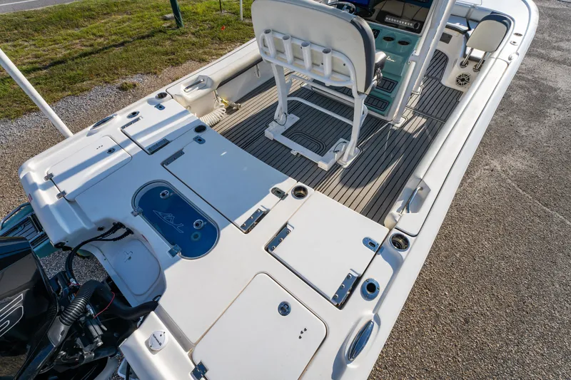 Slide: The Image of 2020 Tidewater 2500 Carolina Bay boat interior with seating and storage compartments. - 18