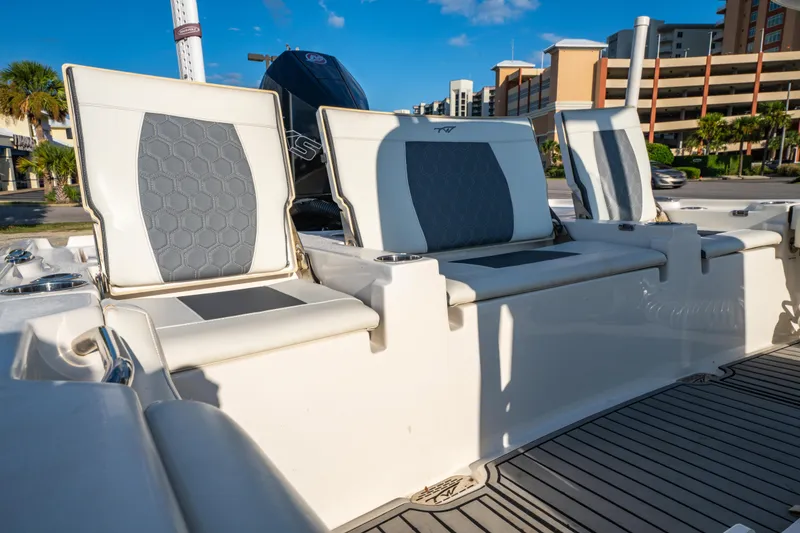 Slide: The Image of 2020 Tidewater 2500 Carolina Bay boat seats with modern design and urban backdrop. - 19