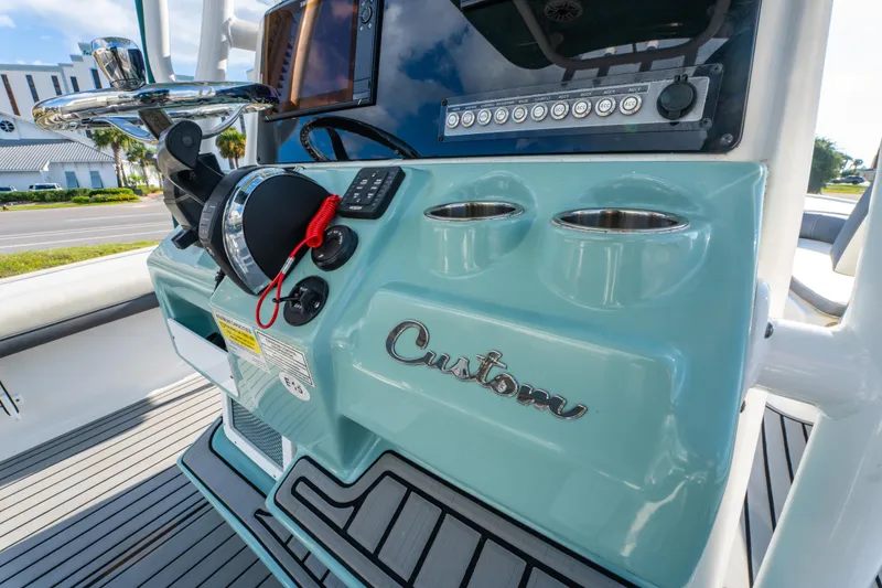 Slide: The Image of 2020 Tidewater 2500 Carolina Bay boat console with steering wheel and controls. - 21