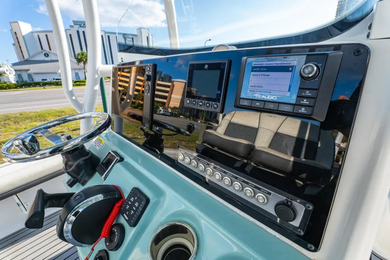 Slide: The Image of 2020 Tidewater 2500 Carolina Bay boat dashboard with modern controls and navigation system. - 22