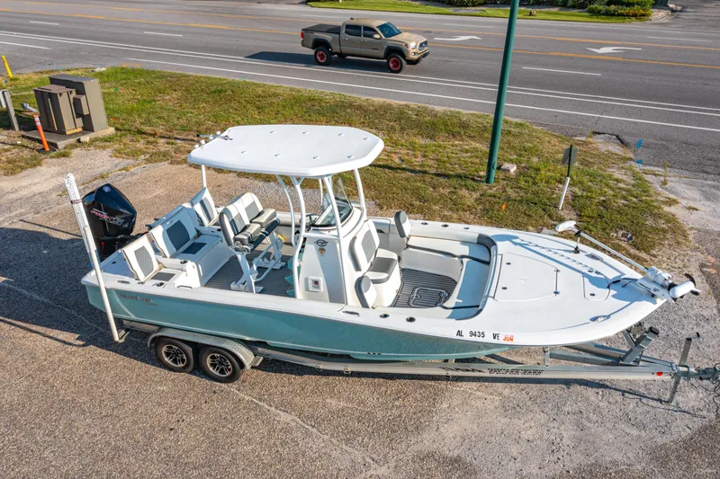 Slide: The Image of 2020 Tidewater 2500 Carolina Bay boat on trailer, parked near a road. - 3