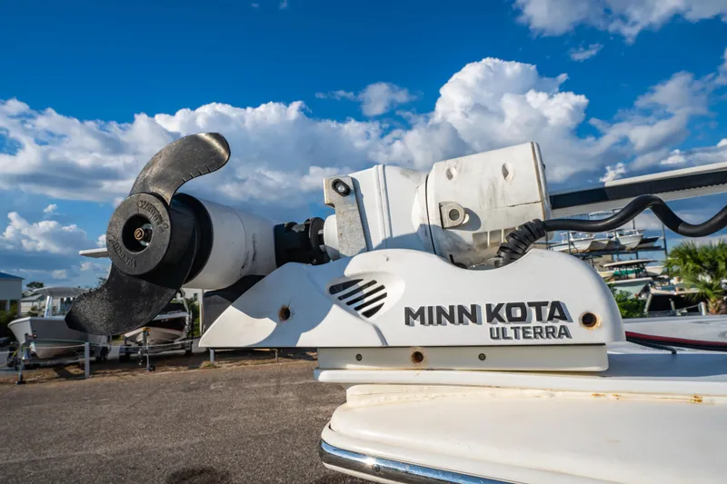 Slide: The Image of 2020 Tidewater 2500 Carolina Bay boat with T-top, urban background, blue sky. - 30