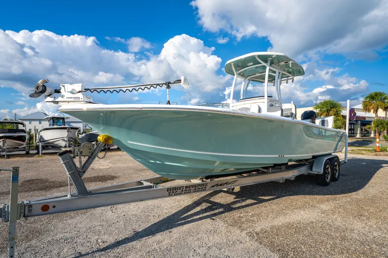 Slide: The Image of 2020 Tidewater 2500 Carolina Bay boat on trailer under blue sky. - 4