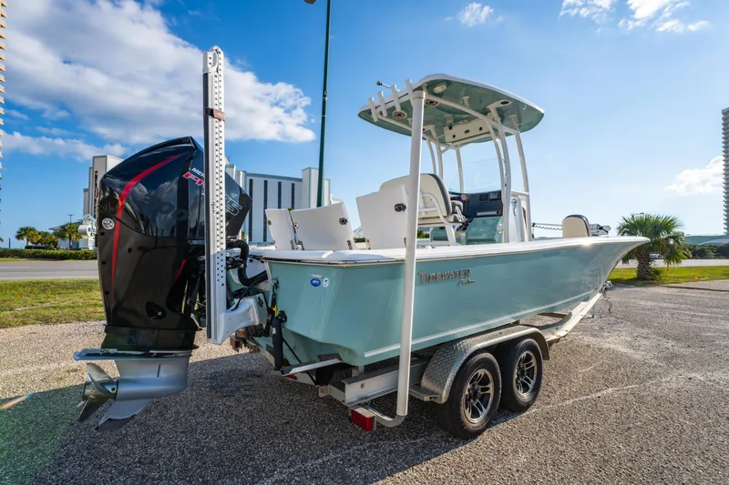 Slide: The Image of 2020 Tidewater 2500 Carolina Bay boat on trailer, featuring a powerful outboard motor. - 9