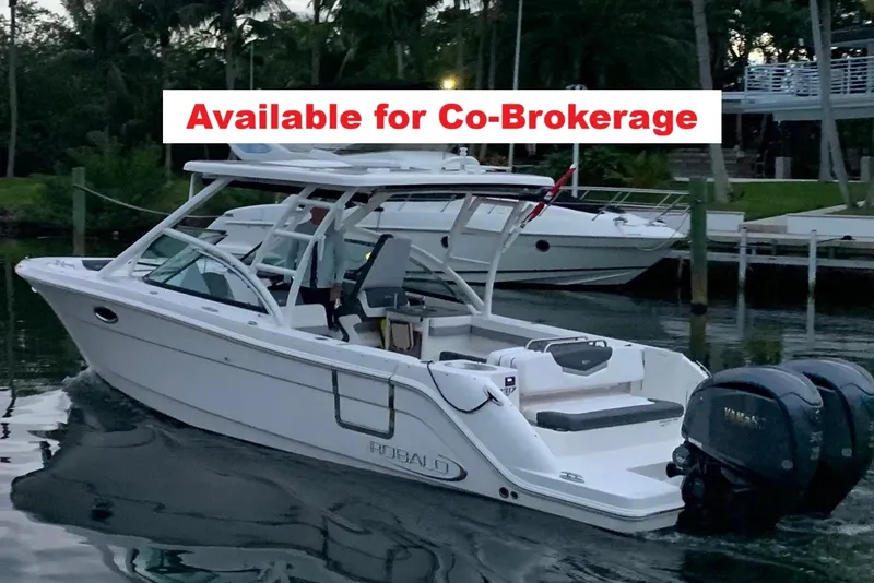 The Image of 2021 Robalo R317 Dual Console boat available for co-brokerage, docked in a serene marina. - 1