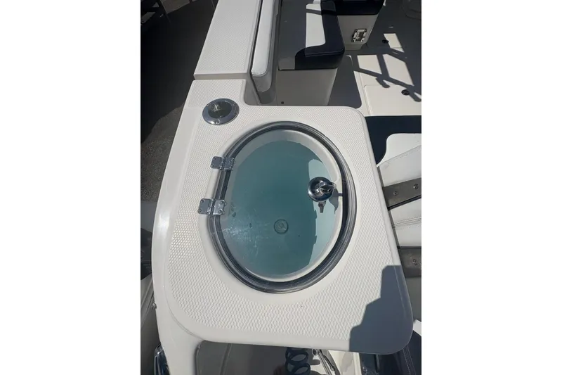 Slide: The Image of 2021 Robalo R317 Dual Console boat with a circular livewell on deck. - 12