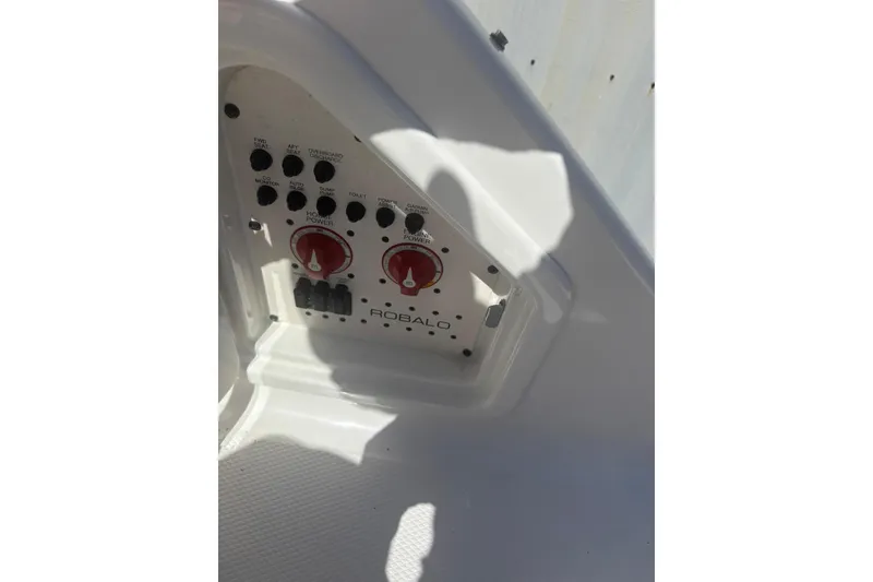 Slide: The Image of Control panel of 2021 Robalo R317 Dual Console boat with switches and dials. - 17