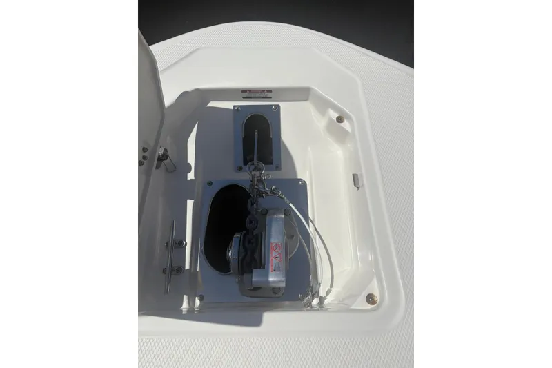 Slide: The Image of 2021 Robalo R317 Dual Console anchor locker with chain and winch. - 19