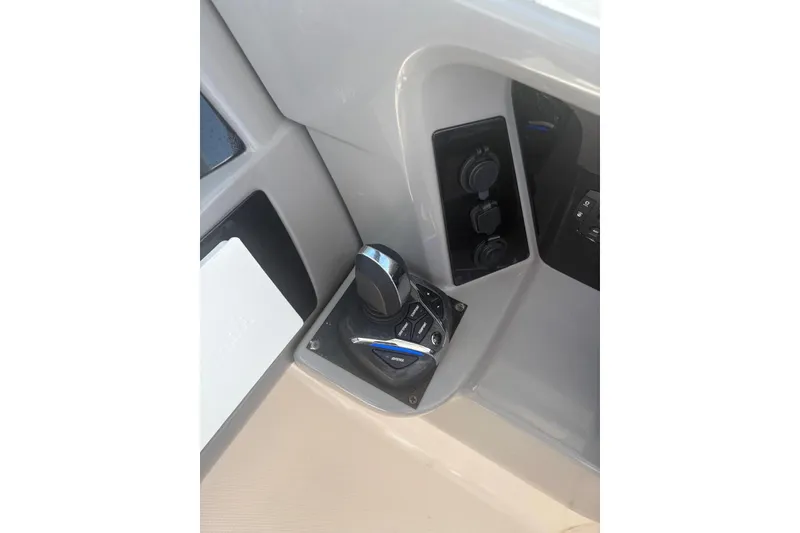 Slide: The Image of Control panel of 2021 Robalo R317 Dual Console boat, featuring joystick and switches. - 8