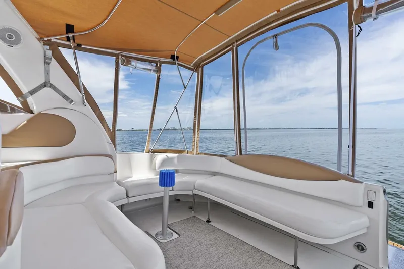 Slide: The Image of 2001 Sea Ray 380 Sundancer interior with white seating and ocean view. - 10