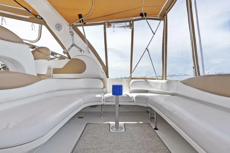 Slide: The Image of Interior of 2001 Sea Ray 380 Sundancer yacht with white seating and canopy. - 11