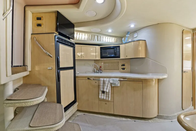 Slide: The Image of 2001 Sea Ray 380 Sundancer interior kitchen with modern appliances and sleek cabinetry. - 15