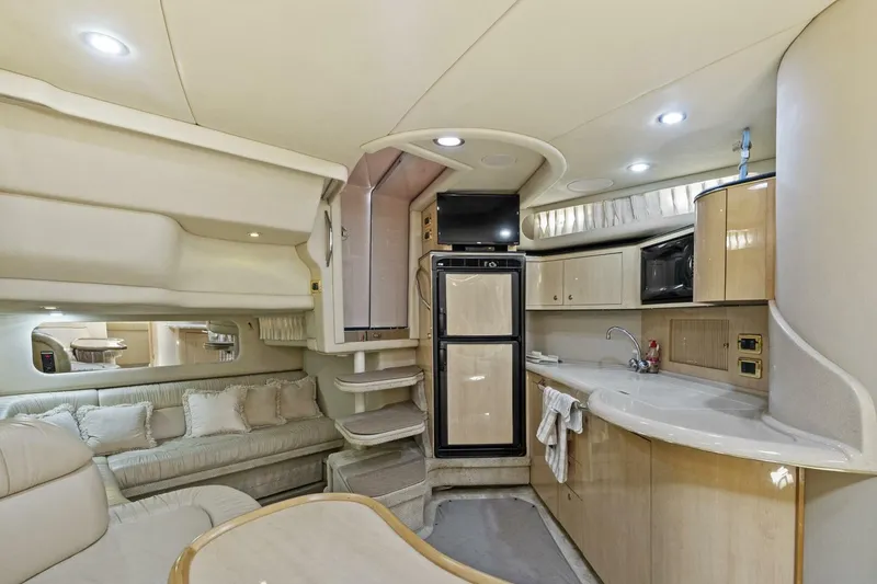 Slide: The Image of Luxurious interior of 2001 Sea Ray 380 Sundancer yacht with modern kitchen and seating area. - 19