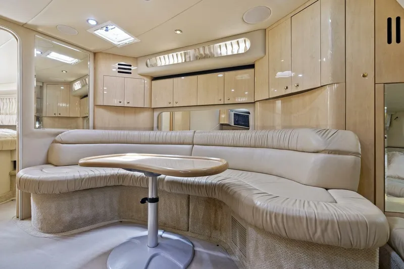 Slide: The Image of Luxurious interior of 2001 Sea Ray 380 Sundancer yacht with plush seating and cabinetry. - 25