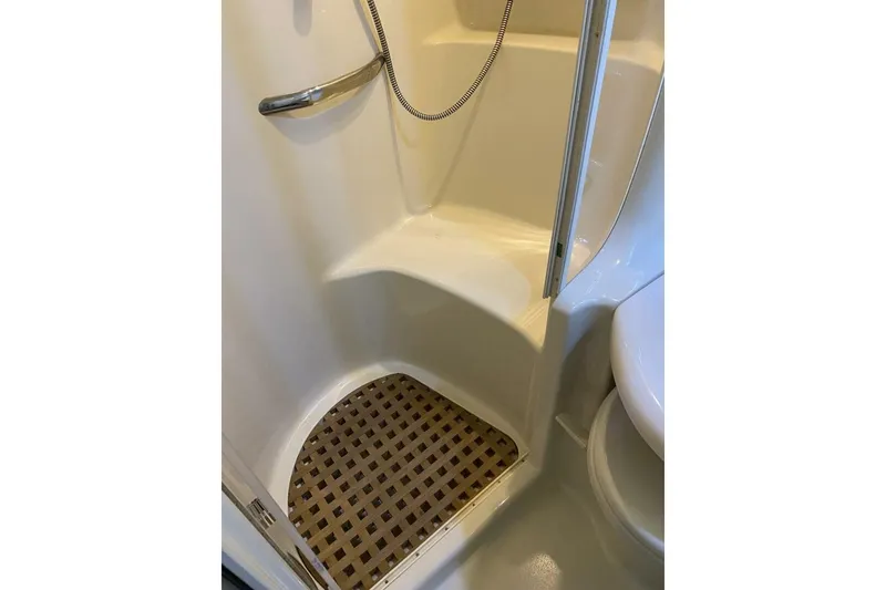 Slide: The Image of Shower area in 2001 Sea Ray 380 Sundancer boat with seating and handheld showerhead. - 28