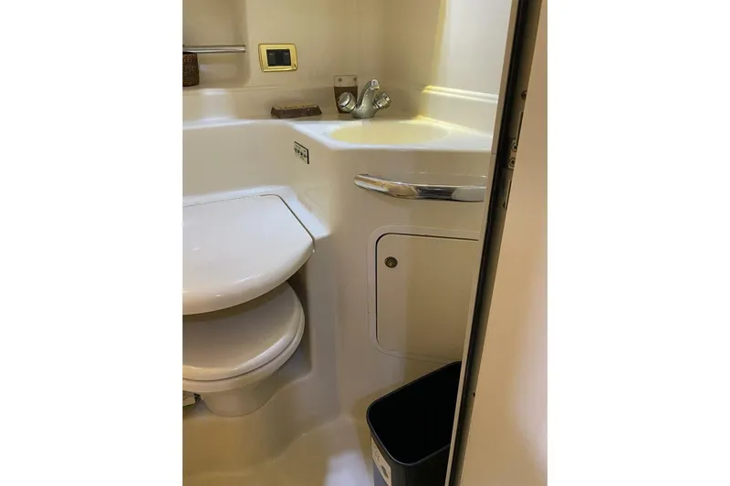 Slide: The Image of 2001 Sea Ray 380 Sundancer bathroom with sink, toilet, and storage cabinet. - 29