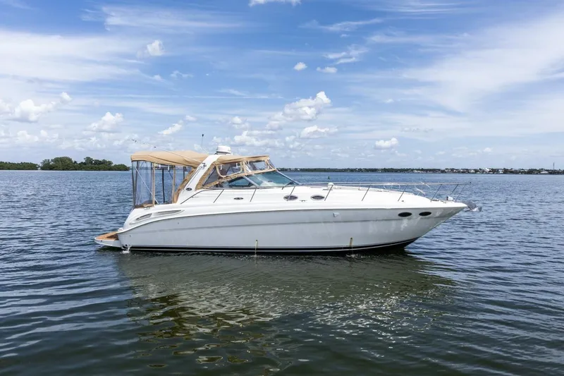 Slide: The Image of 2001 Sea Ray 380 Sundancer yacht on calm water under a clear blue sky. - 4